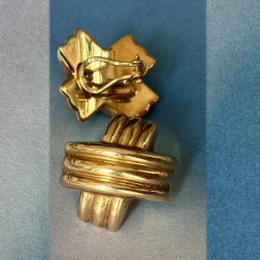 Close-up of a gold metal clip or brooch.