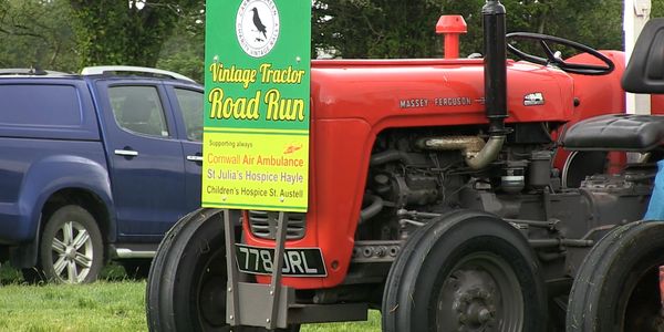 Red Massey-Ferguson tractor with a Vintage Tractor Road Run sign.