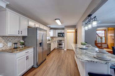 New cabinets, flooring, paint, trim, counter, sink, backsplash and lighting