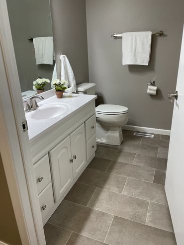 New flooring, vanity with top, faucet, trim and paint