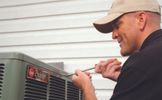 Technician working on a Rheem Classic system