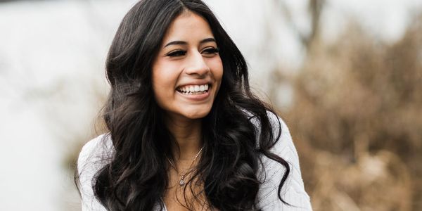 Smiling woman radiating calm, joy and professionalism.