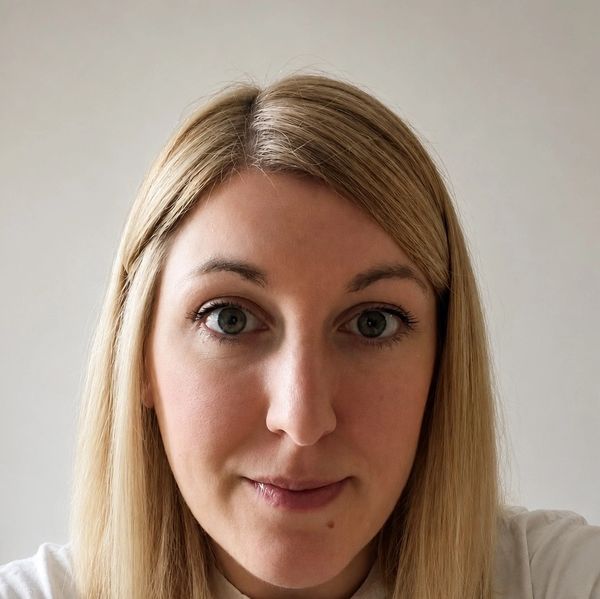 Close-up of a woman with blonde hair and blue eyes.