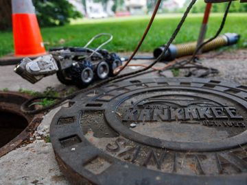 Sewer inspection robot near a manhole cover.