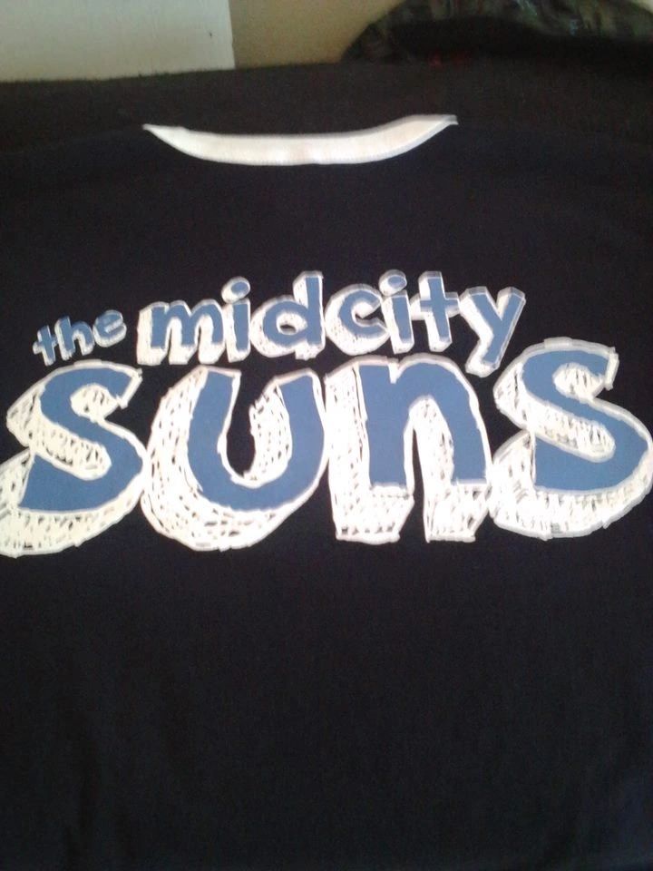 Black shirt with "the midcity suns" text in blue and white.