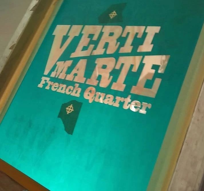 Sign for Verti Marte in the French Quarter with teal background.