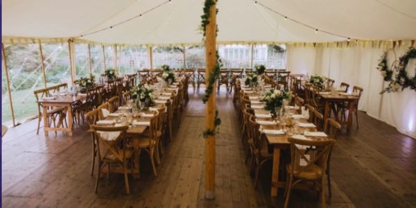 Traditional pole wedding marquee with hard wood flooring