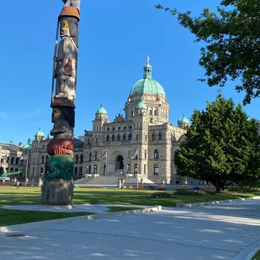 Legislative building and totem pole Victoria BC