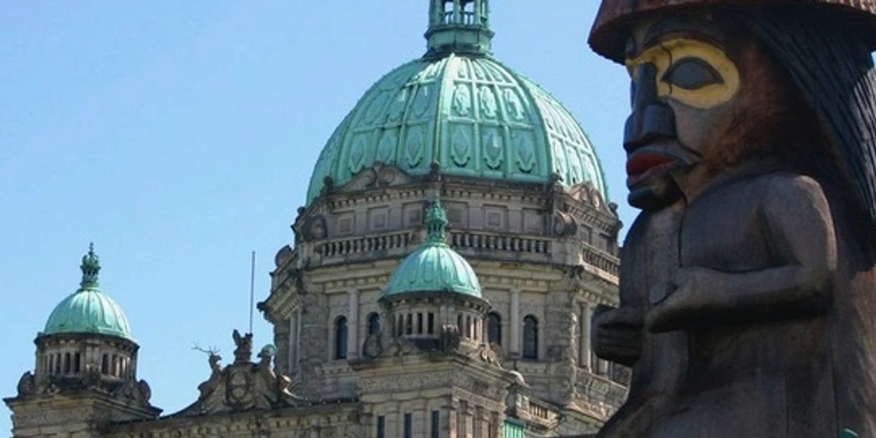First Nation Totem pole close up and Parliament Building, Victoria BC