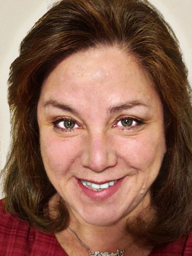 Smiling woman with brown hair and green eyes.
