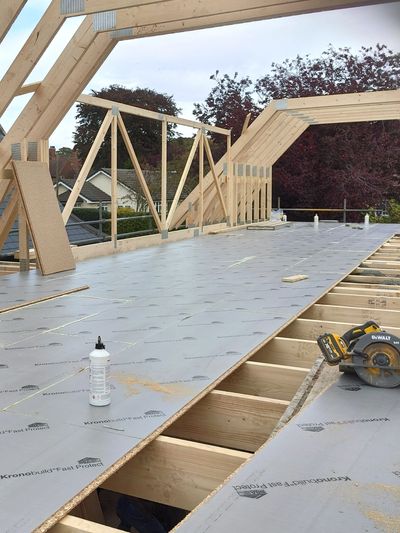Wood framing and flooring under construction on a building site.