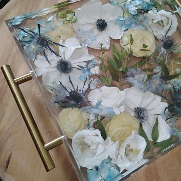 Decorative tray with flowers encased in resin.