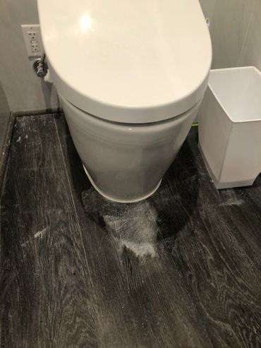 Newly built bathroom left with grout all over the floor and never cleaned up.