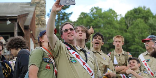 Group of scouts taking a selfie outdoors.