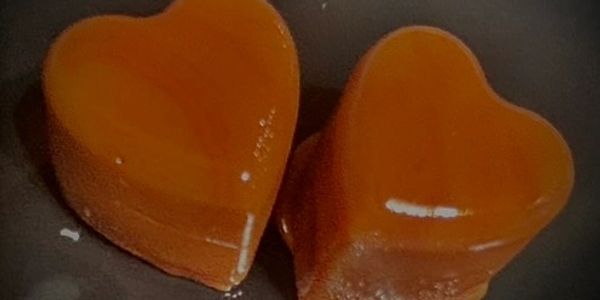 Two heart-shaped caramel candies.