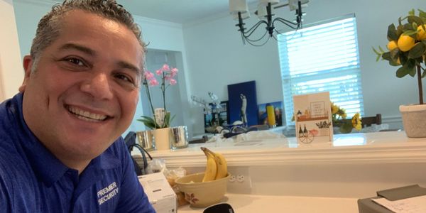 Premier Security technician setting up smart home automation system in Treasure Coast home