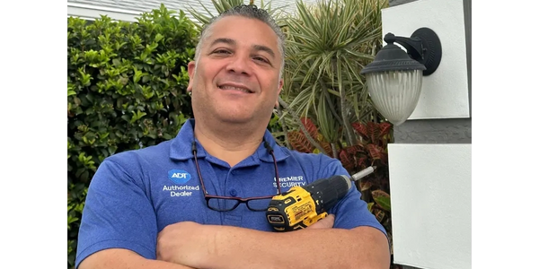 Premier Security technician setting up ADT home alarm in Treasure Coast