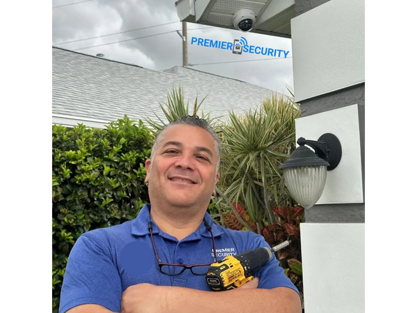 Premier Security technician installing HD CCTV security camera on a home in Port St. Lucie, Florida