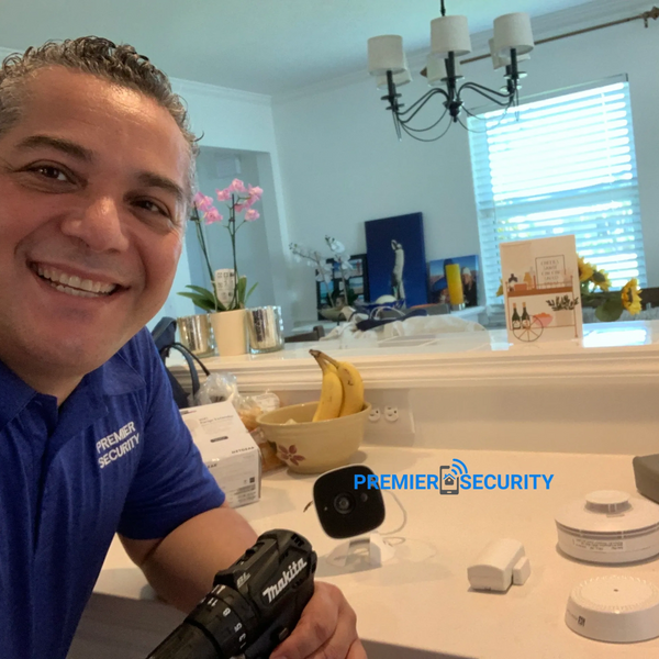 Premier Security technician installing security systems with alarm keypad in Port St.
Lucie home