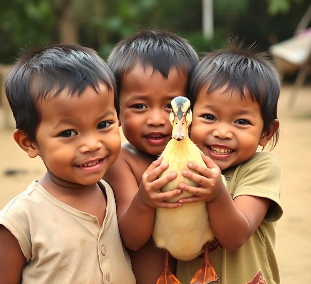 Three children holding a duck, looking ahead