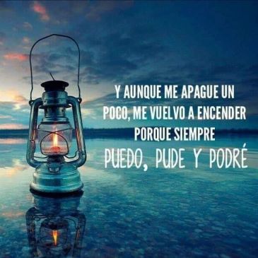 A glowing lantern by water with an inspirational Spanish quote about resilience.