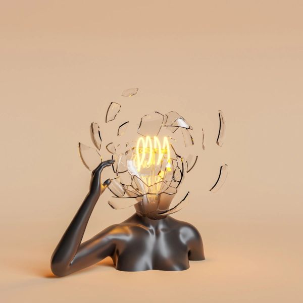 A figure with a shattered light bulb head glowing bright filaments.