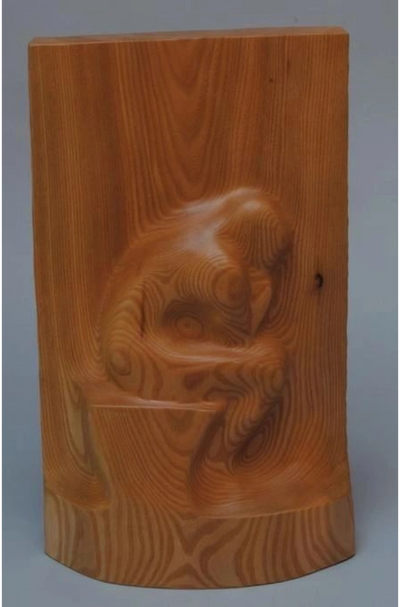 Pine wood carving, abstract and smooth, with a flowing, elongated form