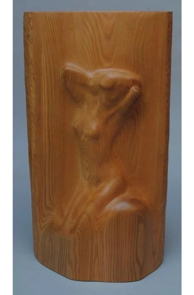 Cherokee wood carving depicting a human-like figure with expressive features
