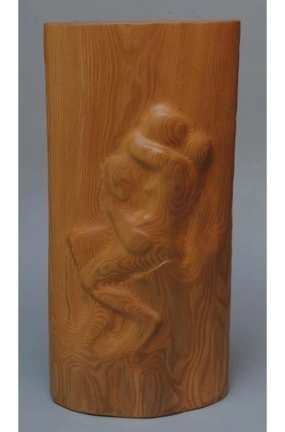 First wood carving: an abstract, elongated form with a polished finish and natural base