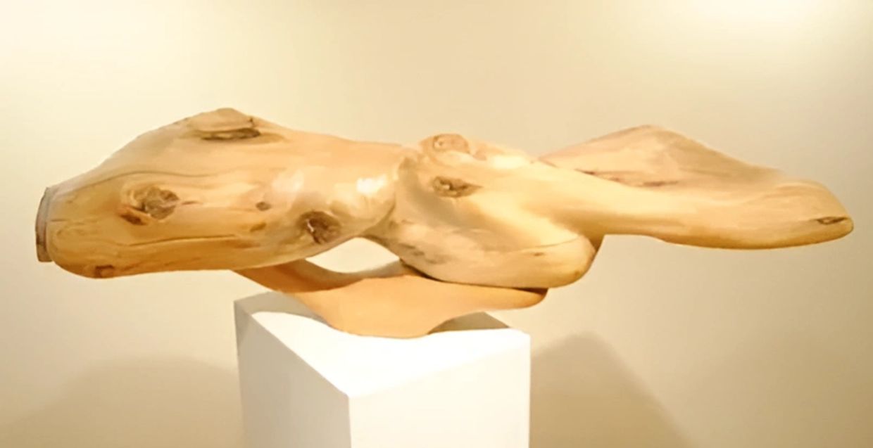 Polished wood sculpture in the style of Kiki Smith, with flowing, organic forms