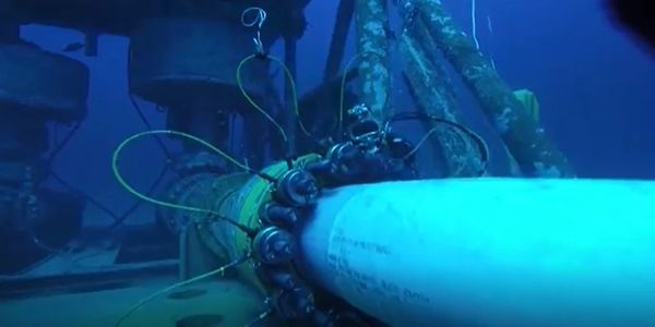 Underwater pipeline with inspection devices attached for maintenance.