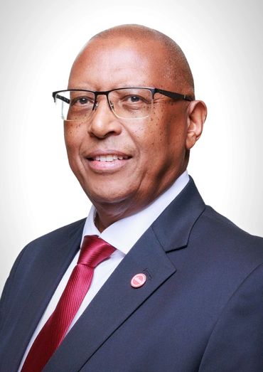 Professional portrait of a man in a suit with glasses and a red tie.
