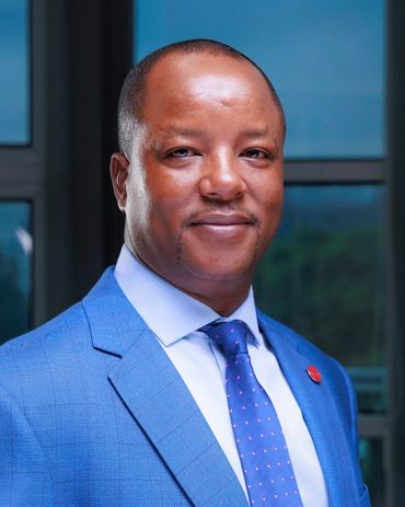 Professional man in a blue suit and tie, smiling confidently.