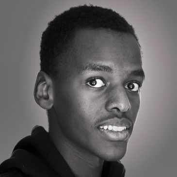 Black and white portrait of a young man with a contemplative expression.