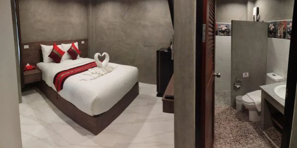 Modern hotel room with a cozy bed and attached bathroom.