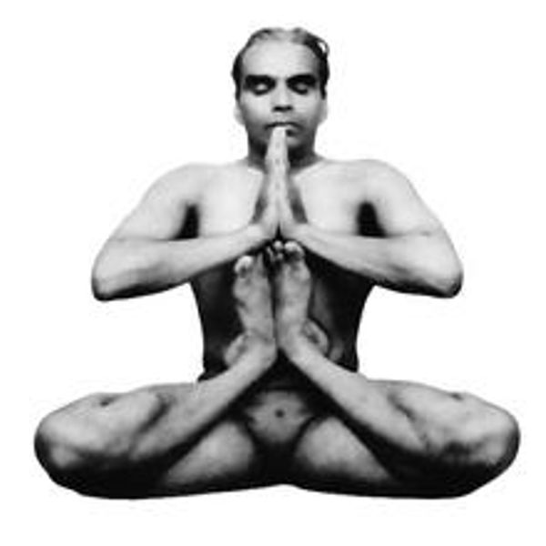 Man in a yoga pose with hands and feet joined in prayer gesture.
