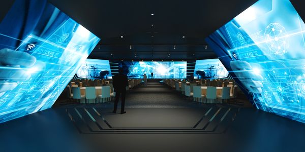 Futuristic conference room with digital screens and silhouettes of people.