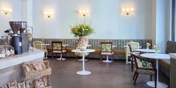 Bright and cozy cafe with floral decor and modern seating.
