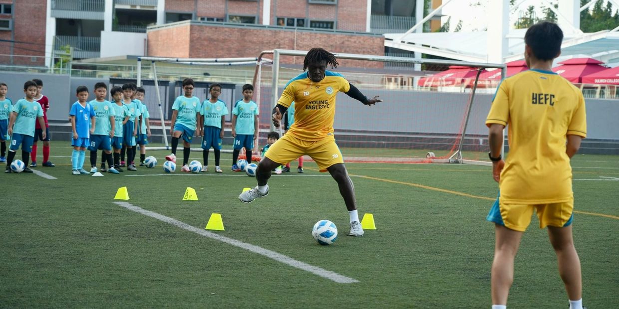 Young Eagles FC Co-Founder and Academy Director, Coach Dennis, demonstrating a ball control drill. 