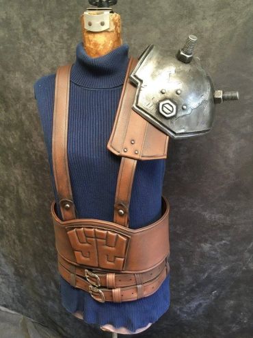Leather harness and metal shoulder armor on mannequin.