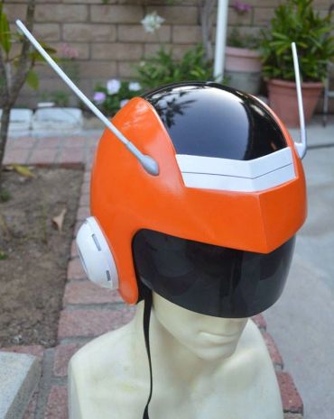 Orange and black sci-fi helmet with antennas.