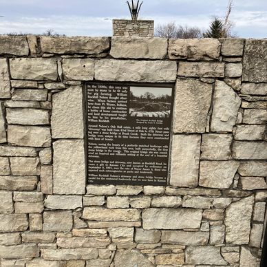 Plaque on north bound lane of Rockhill Road bridge over Brush Creek.