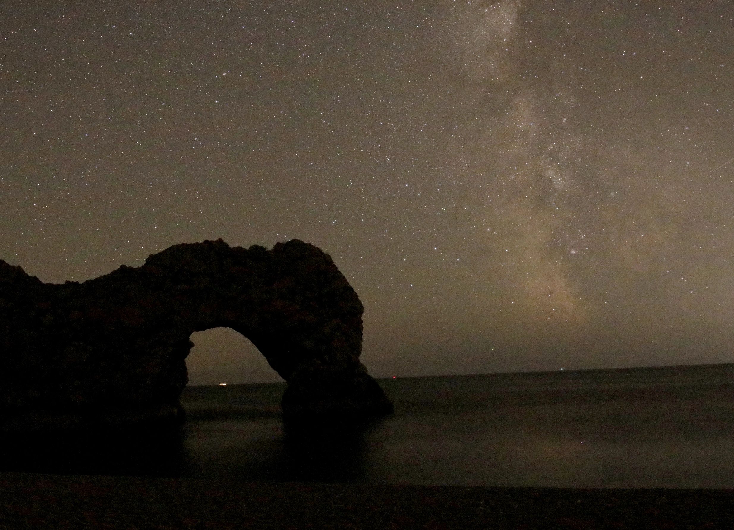 The milky way rising over Durdle Door beach in Dorset