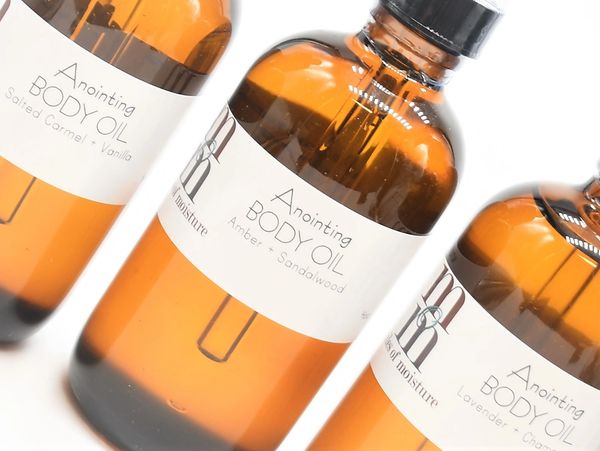 Amber bottles of anointing body oil with dropper caps.