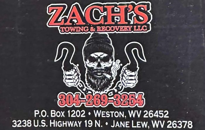 Logo for Zach's Towing & Recovery LLC with contact info and a skull graphic.