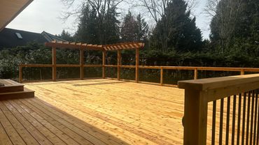 large custom deck with custom wood and metal deck railings