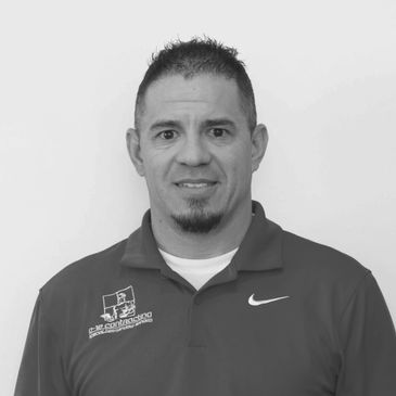 Black and white portrait of a man in a polo shirt.
