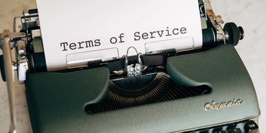 Photo by Markus Winker (Pexels) of a typewriter with the typed words "Terms of Service". 