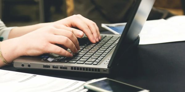 Typing on a laptop