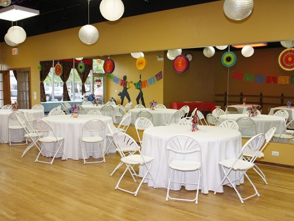 Studio space with tables and chairs available for birthday parties, graduations, baby showers